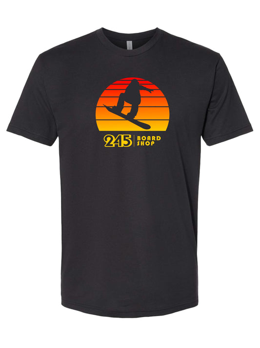 dark grey tee with a snowboarder jumping, sunset background